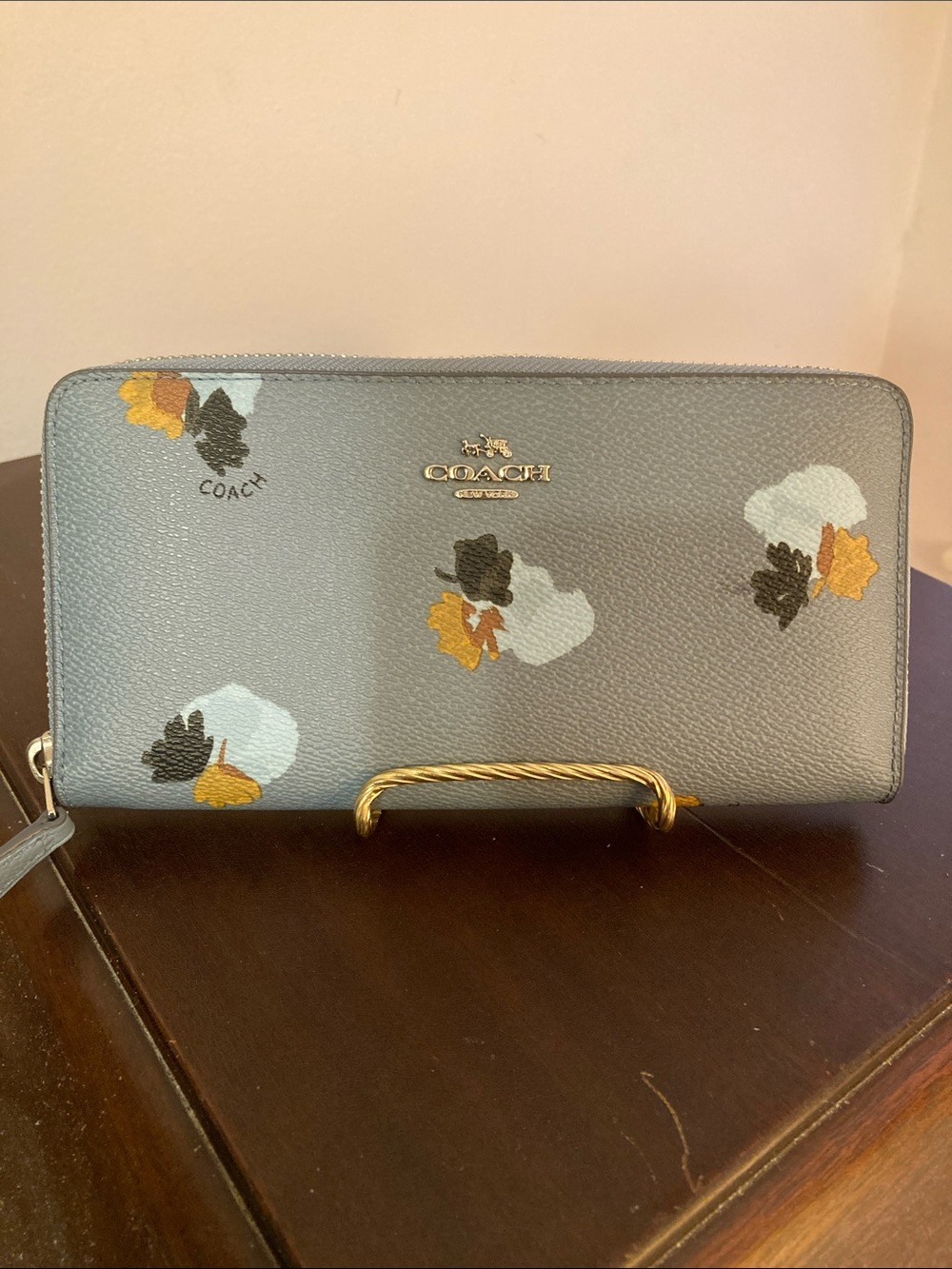 Coach EUC Accordion Zip Wallet “Field Flora” print on light blue coated canvas.